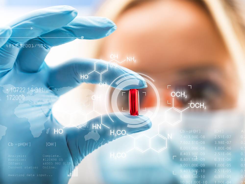 Scientist holding a capsule with digital chemical structure overlays and data graphics in the background.