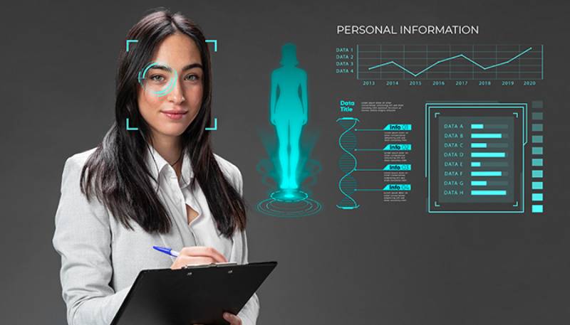 A woman stands with a clipboard, surrounded by futuristic holographic displays of personal data and analytics.